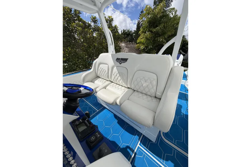  Yacht Photos Pics Luxurious white seating on 2012 Deep Impact 399 Sport boat with blue accents.