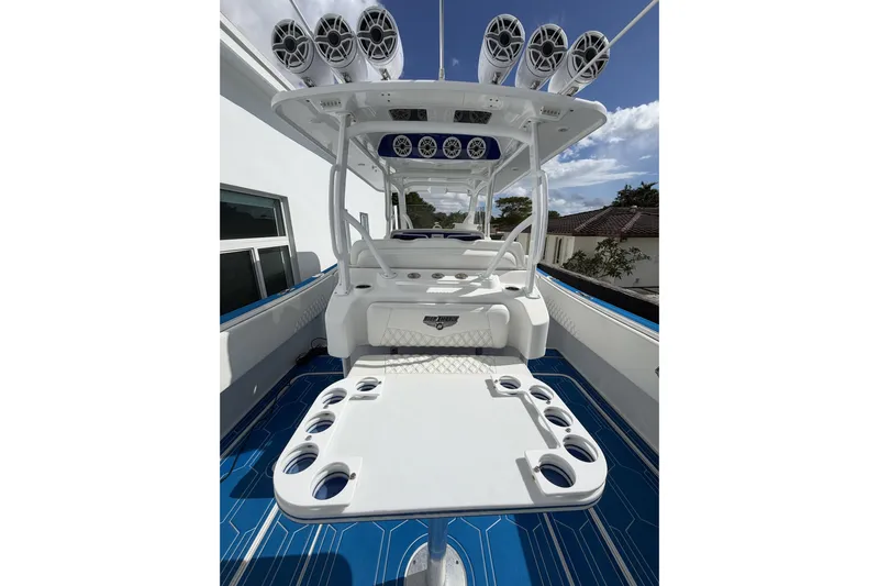 Yacht Photos Pics 2012 Deep Impact 399 Sport boat interior with speakers and seating, featuring a sleek design.