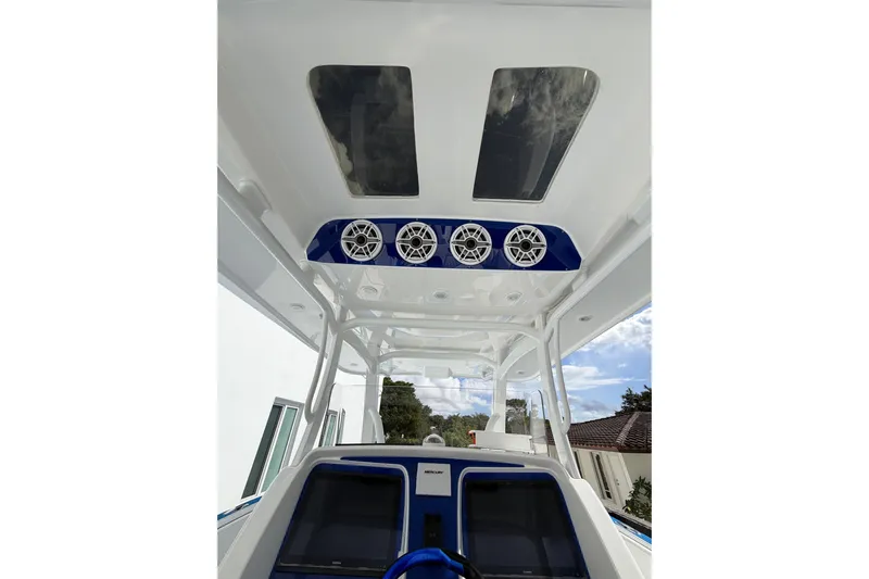  Yacht Photos Pics 2012 Deep Impact 399 Sport boat interior with speakers and skylights.