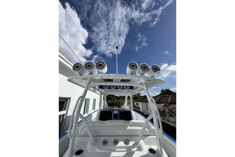  Yacht Photos Pics 2012 Deep Impact 399 Sport boat with speakers, clear sky background.