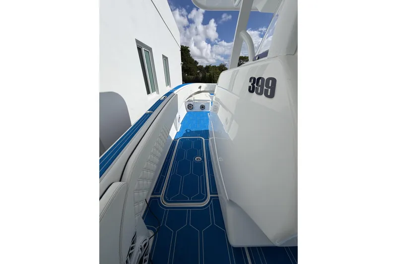  Yacht Photos Pics 2012 Deep Impact 399 Sport boat with blue deck, white seating, and modern design.