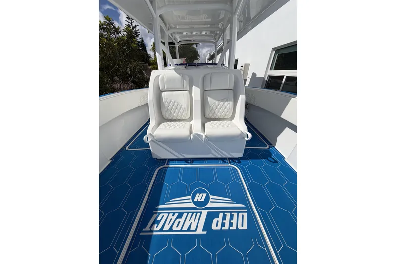  Yacht Photos Pics 2012 Deep Impact 399 Sport boat interior with white seats and blue flooring.