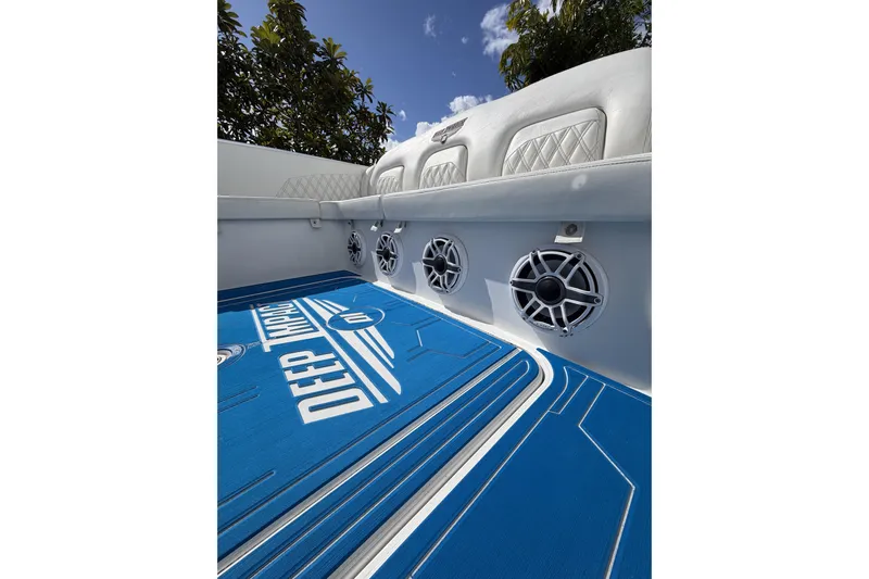  Yacht Photos Pics Interior of 2012 Deep Impact 399 Sport boat with blue flooring and speakers.