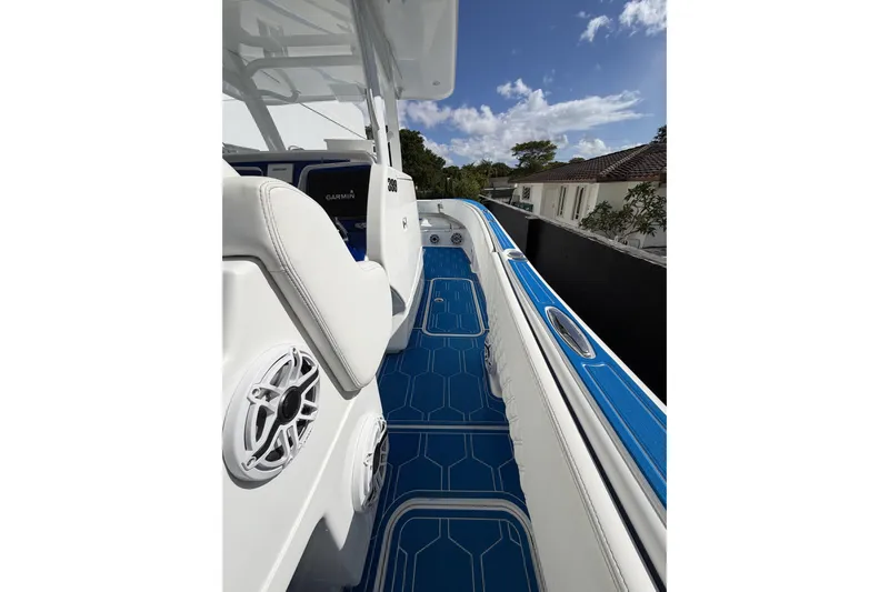  Yacht Photos Pics 2012 Deep Impact 399 Sport boat interior with blue flooring and white seating.