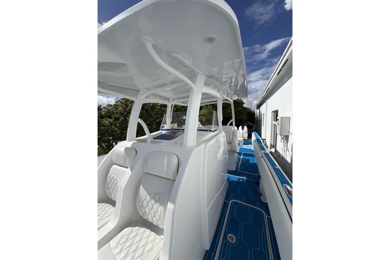  Yacht Photos Pics 2012 Deep Impact 399 Sport boat interior with white seating and blue flooring.