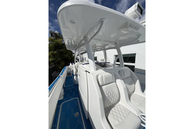  Yacht Photos Pics 2012 Deep Impact 399 Sport boat with sleek white seating and blue deck.