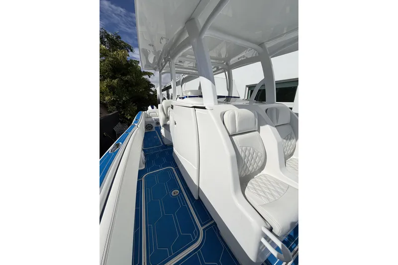  Yacht Photos Pics 2012 Deep Impact 399 Sport boat with white seating and blue deck.