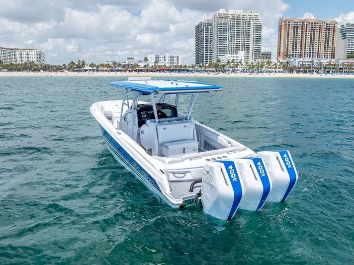  Yacht Photos Pics 2025 Nor-Tech 340 Sport boat with triple engines on ocean near city skyline.