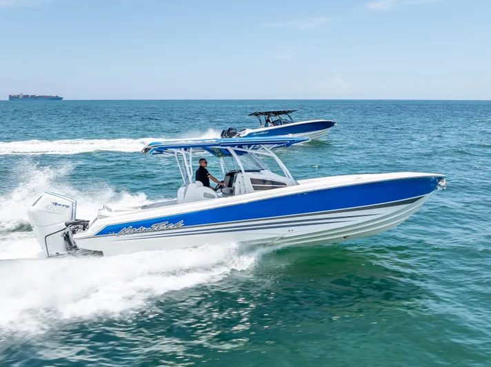 Yacht Photos Pics 2025 Nor-Tech 340 Sport boat cruising on open water, showcasing sleek design and performance.