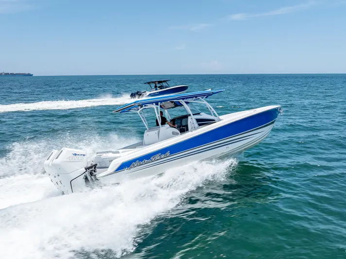  Yacht Photos Pics 2025 Nor-Tech 340 Sport boat cruising on open ocean under clear blue sky.