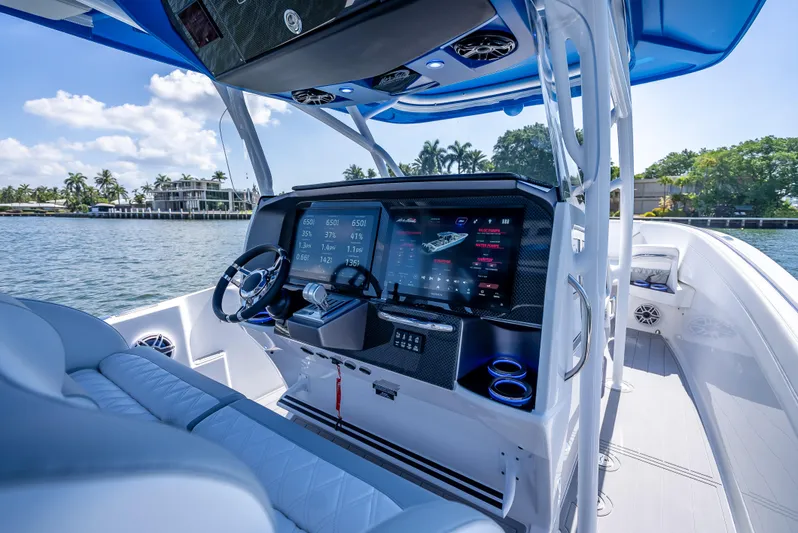  Yacht Photos Pics 2025 Nor-Tech 340 Sport boat cockpit with advanced navigation system, luxurious seating, and scenic water view.