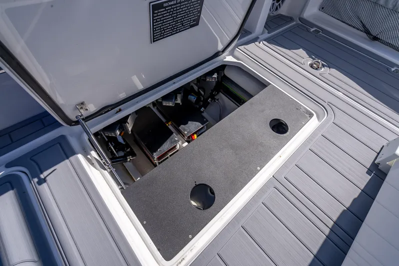  Yacht Photos Pics 2025 Nor-Tech 340 Sport boat storage compartment with open hatch, showcasing interior details.