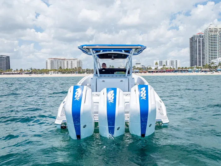  Yacht Photos Pics 2025 Nor-Tech 340 Sport boat with triple engines on open water, city skyline in background.