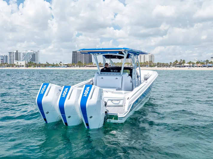  Yacht Photos Pics 2025 Nor-Tech 340 Sport boat with triple outboard engines on open water.