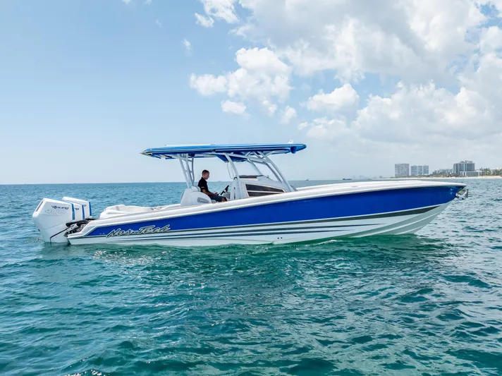  Yacht Photos Pics 2025 Nor-Tech 340 Sport boat on open water, featuring sleek blue and white design.