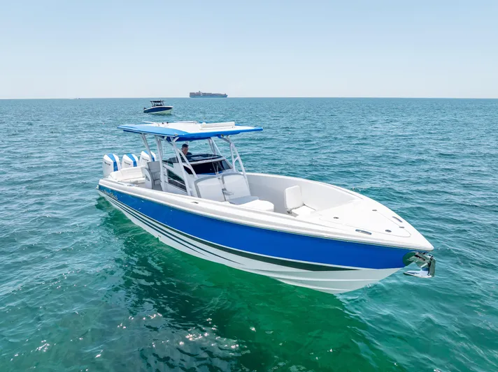  Yacht Photos Pics 2025 Nor-Tech 340 Sport boat on open sea, featuring sleek blue and white design.