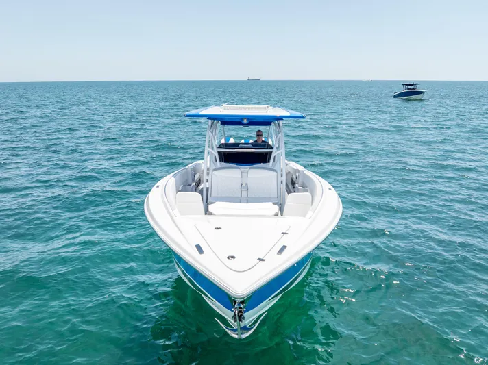 Yacht Photos Pics 2025 Nor-Tech 340 Sport boat on open water, showcasing sleek design and vibrant blue accents.