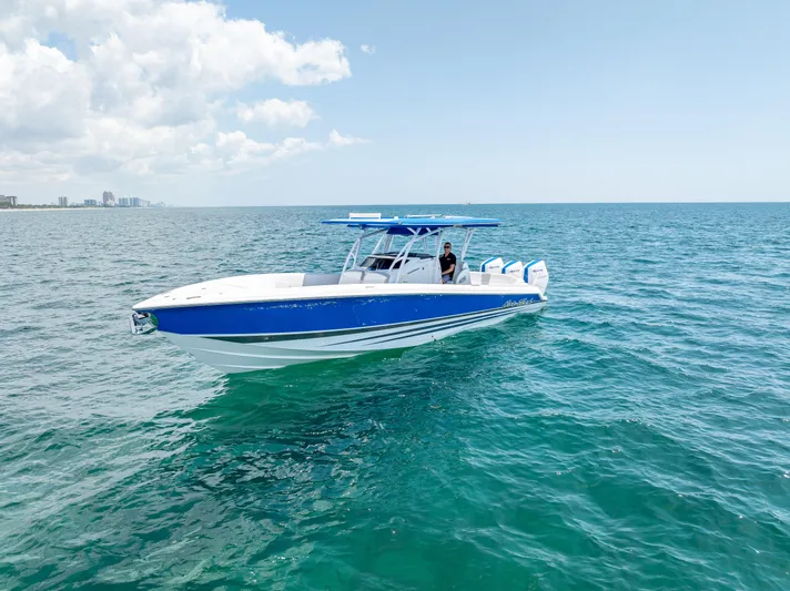  Yacht Photos Pics 2025 Nor-Tech 340 Sport boat cruising on open ocean under clear blue sky.