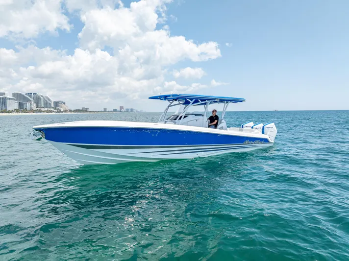  Yacht Photos Pics 2025 Nor-Tech 340 Sport boat on open water, blue and white design, clear sky background.