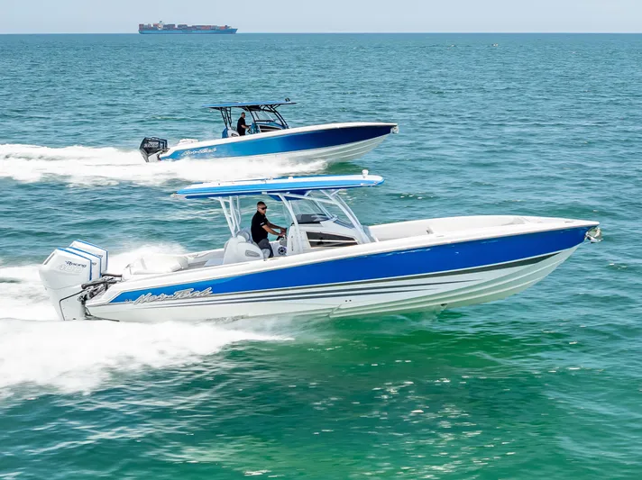  Yacht Photos Pics 2025 Nor-Tech 340 Sport boats cruising on open water, showcasing sleek design and performance.