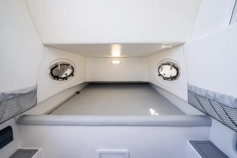  Yacht Photos Pics Interior cabin of 2025 Nor-Tech 340 Sport boat, featuring sleek design and porthole windows.