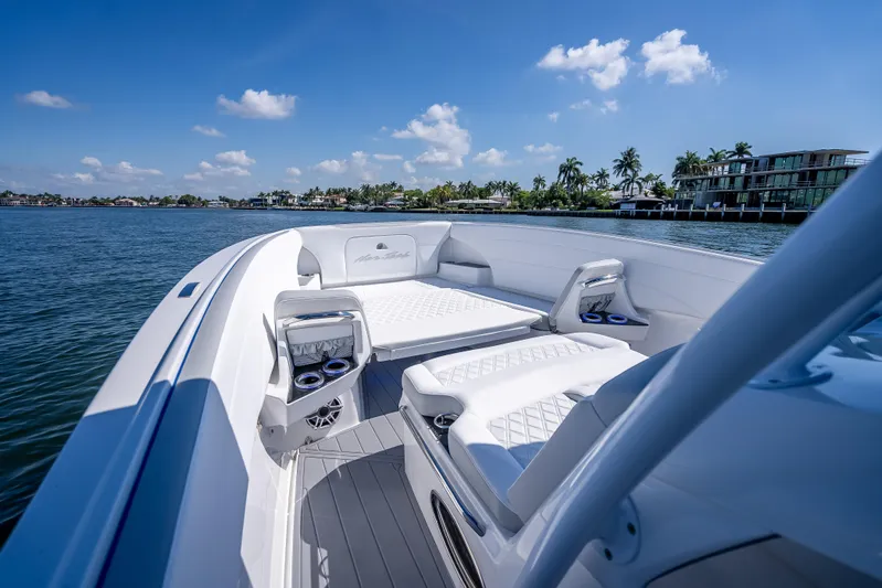  Yacht Photos Pics 2025 Nor-Tech 340 Sport boat interior with luxurious seating, cruising on a sunny day.