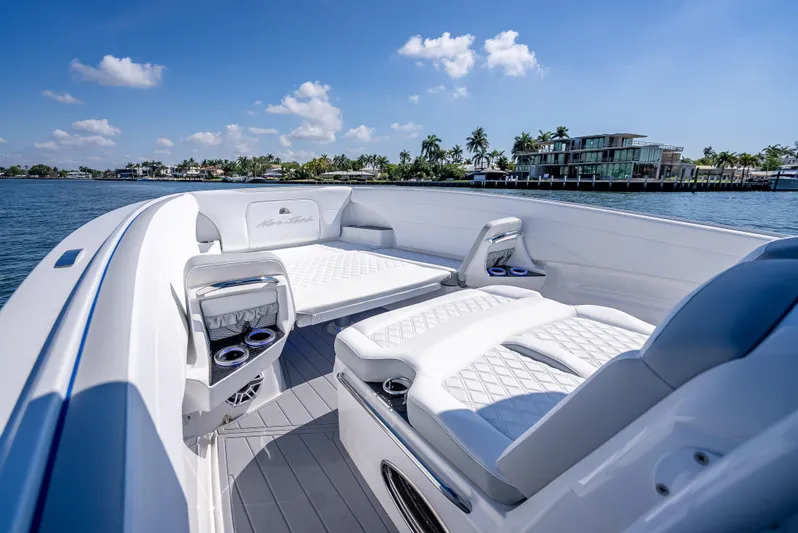  Yacht Photos Pics 2025 Nor-Tech 340 Sport boat interior with luxurious seating, on a sunny day by the water.
