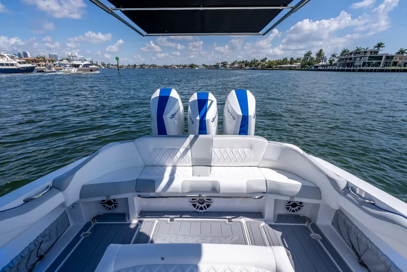  Yacht Photos Pics 2025 Nor-Tech 340 Sport boat with triple engines, spacious seating, and scenic waterfront view.
