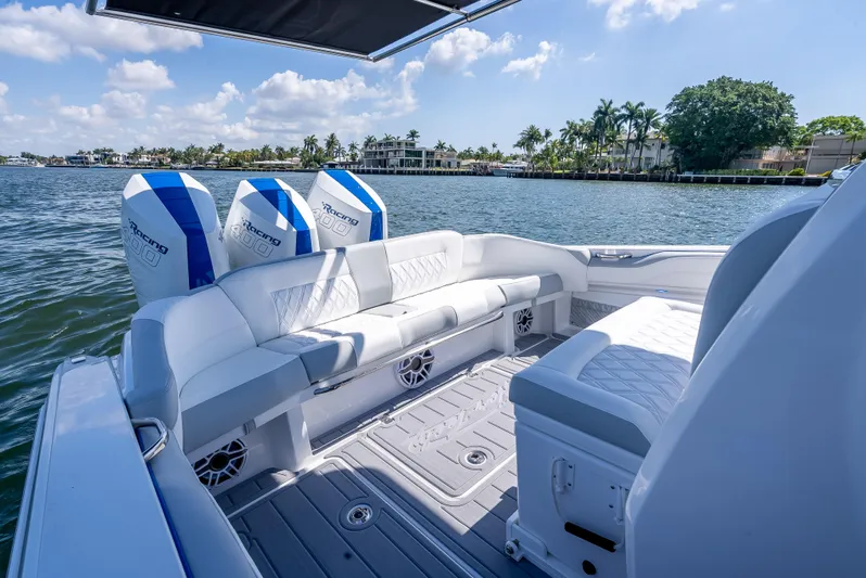  Yacht Photos Pics 2025 Nor-Tech 340 Sport boat with luxurious seating, triple engines, and scenic waterfront view.