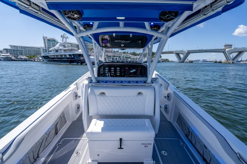  Yacht Photos Pics 2025 Nor-Tech 340 Sport boat interior with modern console, docked near a bridge.