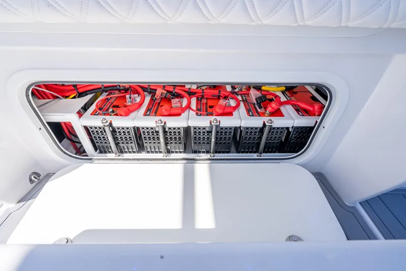  Yacht Photos Pics 2025 Nor-Tech 340 Sport battery compartment with red wiring and secure housing.