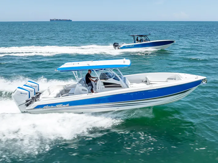  Yacht Photos Pics 2025 Nor-Tech 340 Sport boats cruising on open water, showcasing sleek design and performance.