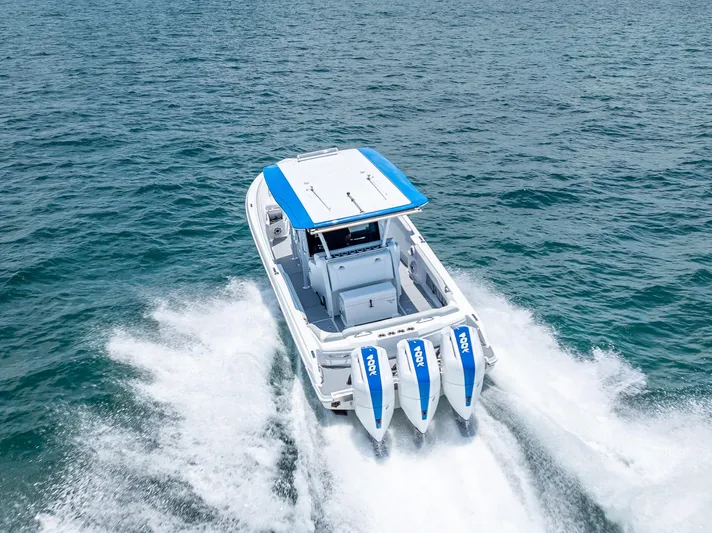  Yacht Photos Pics 2025 Nor-Tech 340 Sport boat cruising on open water with triple engines.