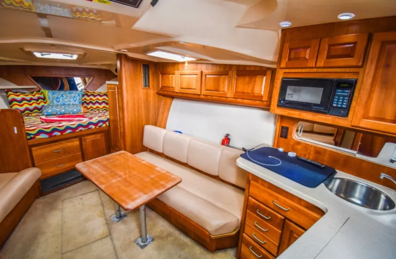 Rocky N Friends Yacht Photos Pics Interior of 2003 Luhrs 36 Open yacht with cozy seating and kitchenette.