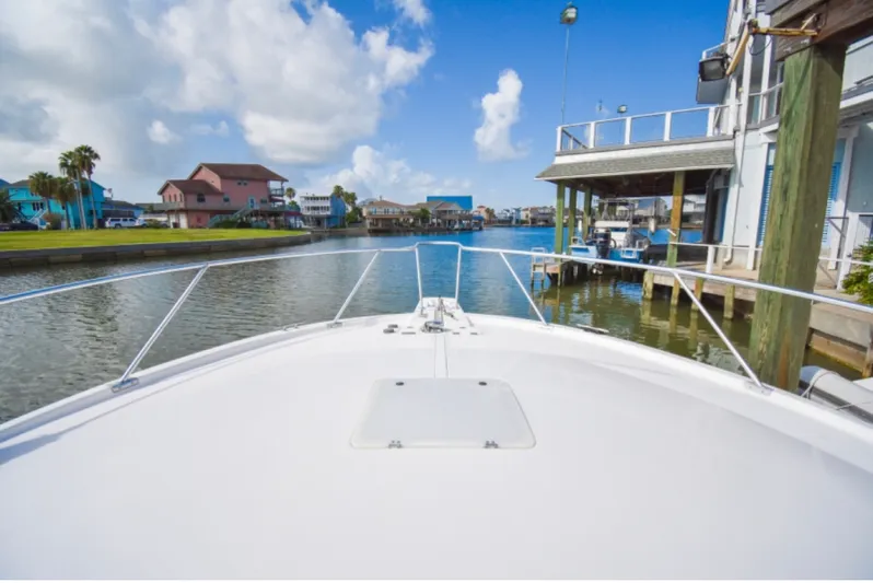 Rocky N Friends Yacht Photos Pics Bow view from 2003 Luhrs 36 Open boat in a scenic canal setting.