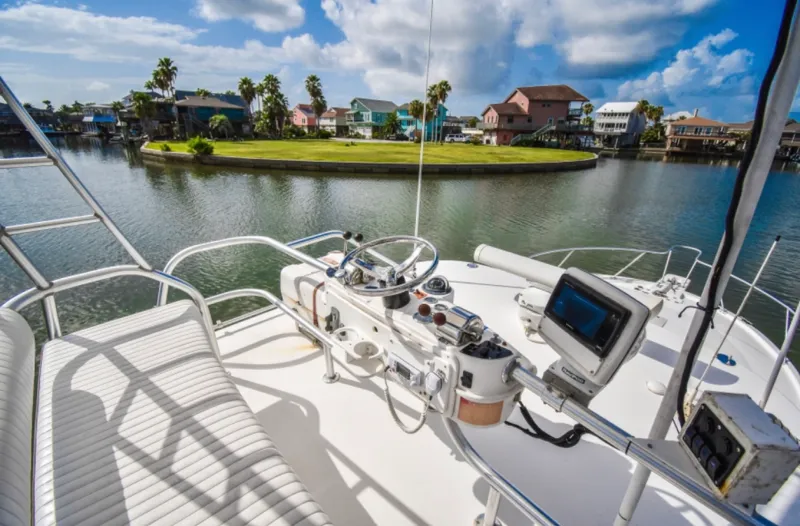 Rocky N Friends Yacht Photos Pics 2003 Luhrs 36 Open yacht helm with scenic waterfront view.