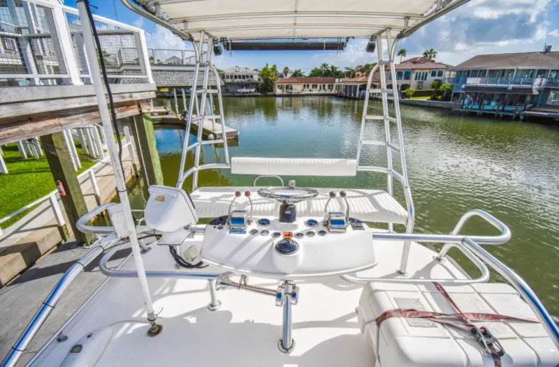 Rocky N Friends Yacht Photos Pics 2003 Luhrs 36 Open boat helm with waterfront view.