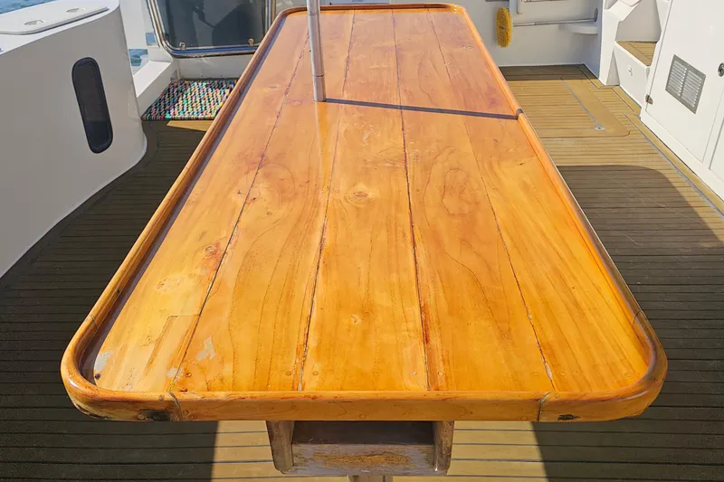 Nantucket Sleighride Yacht Photos Pics Wooden table on a 2005 Custom Sea Raider Catamaran deck.