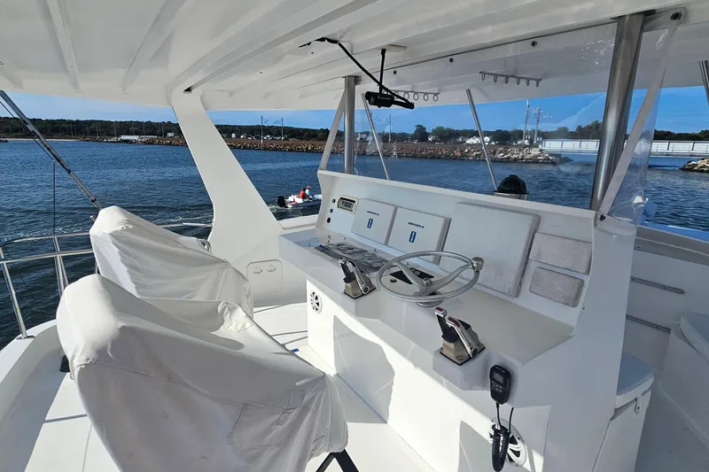 Nantucket Sleighride Yacht Photos Pics Helm of 2005 Custom Sea Raider Catamaran with dual controls, overlooking serene waters.