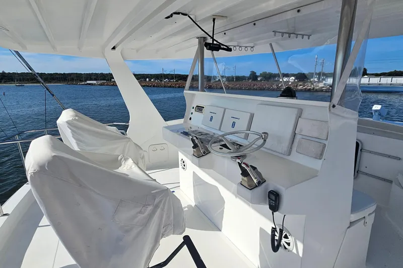 Nantucket Sleighride Yacht Photos Pics Helm of 2005 Custom Sea Raider Catamaran with dual controls, overlooking serene waters.