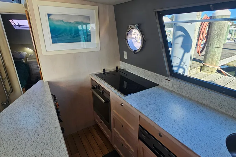 Nantucket Sleighride Yacht Photos Pics Interior of 2005 Custom Sea Raider Catamaran with modern kitchen and ocean-themed decor.