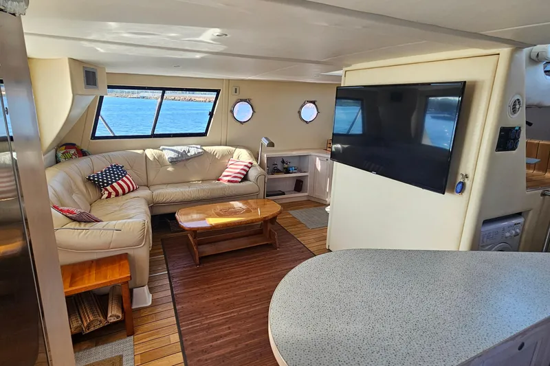 Nantucket Sleighride Yacht Photos Pics Luxurious interior of 2005 Custom Sea Raider Catamaran with leather seating and large TV.