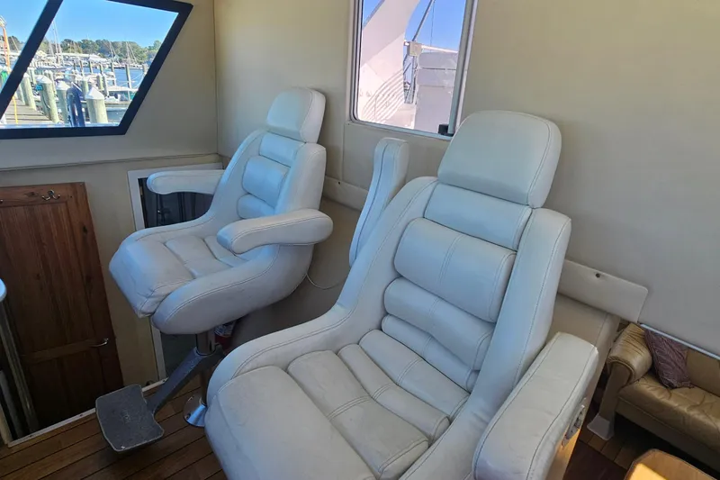 Nantucket Sleighride Yacht Photos Pics Interior of 2005 Custom Sea Raider Catamaran with plush white captain chairs.