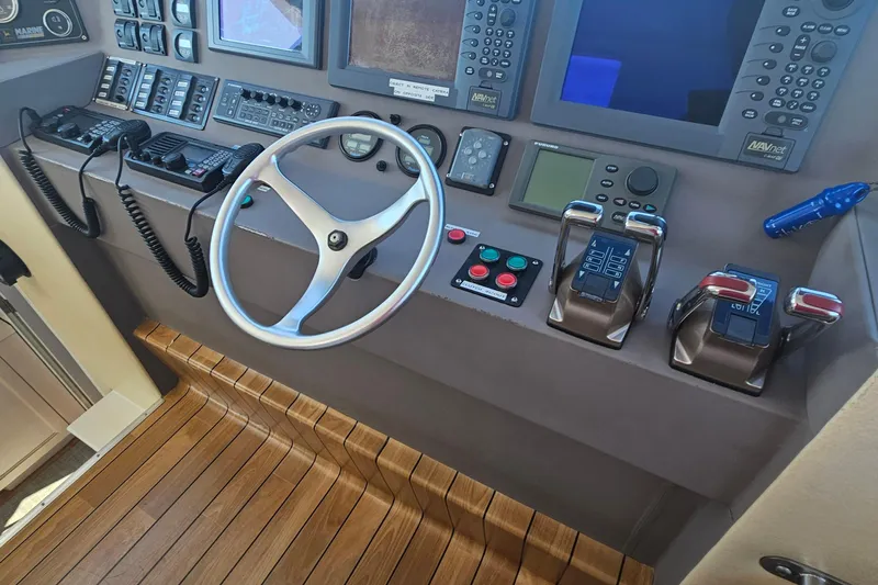 Nantucket Sleighride Yacht Photos Pics Control panel of 2005 Custom Sea Raider Catamaran with steering wheel and navigation equipment.