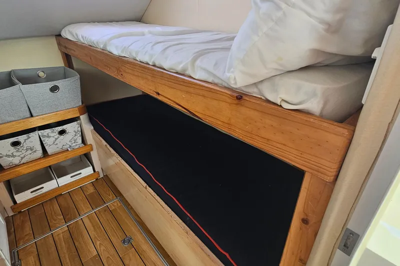 Nantucket Sleighride Yacht Photos Pics Bunk beds and storage in 2005 Custom Sea Raider Catamaran cabin interior.