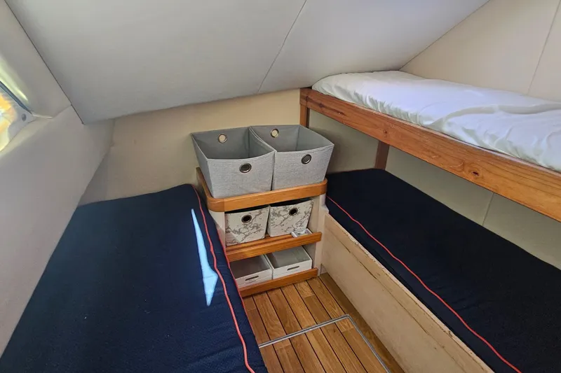 Nantucket Sleighride Yacht Photos Pics Interior of 2005 Custom Sea Raider Catamaran with bunk beds and storage baskets.