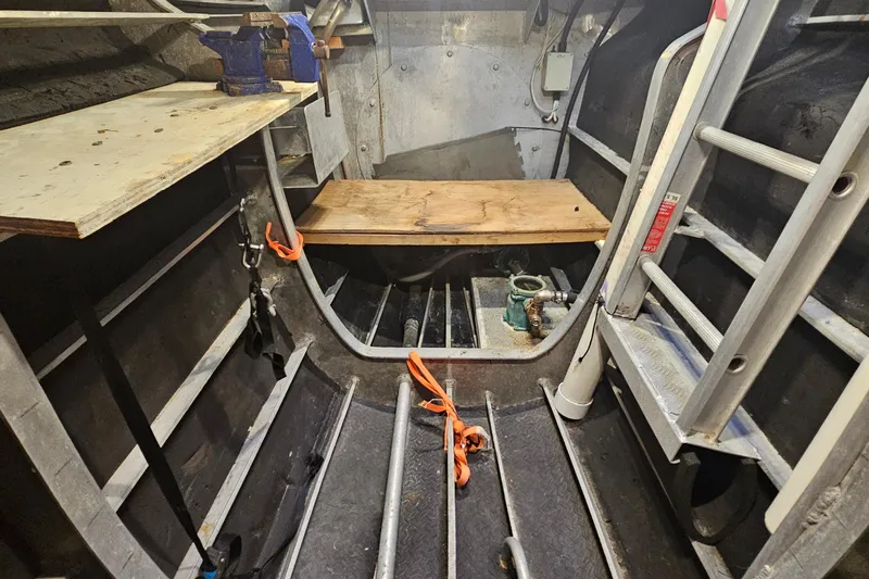 Nantucket Sleighride Yacht Photos Pics Interior of a 2005 Custom Sea Raider Catamaran, featuring a workbench and ladder.