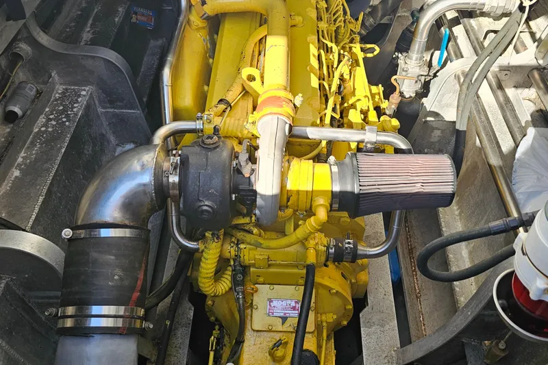 Nantucket Sleighride Yacht Photos Pics Engine of a 2005 Custom Sea Raider Catamaran, featuring yellow components and metal piping.