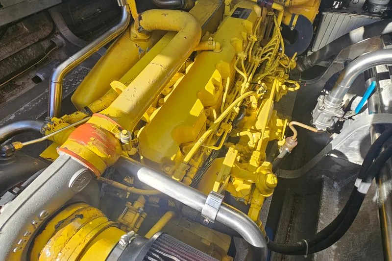 Nantucket Sleighride Yacht Photos Pics Yellow engine of a 2005 Custom Sea Raider Catamaran with visible pipes and components.