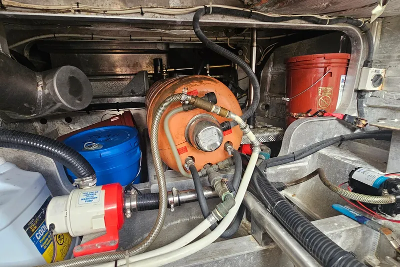 Nantucket Sleighride Yacht Photos Pics Engine room of a 2005 Custom Sea Raider Catamaran with various equipment and hoses.